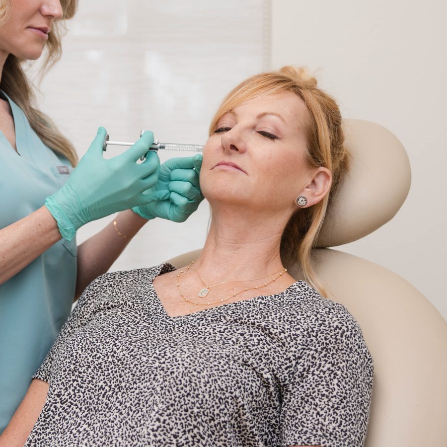 Injector giving a woman a dermal filler injection for the $300 off Full Refresh filler October special in Lakewood Ranch, Bradenton, and Venice, Florida