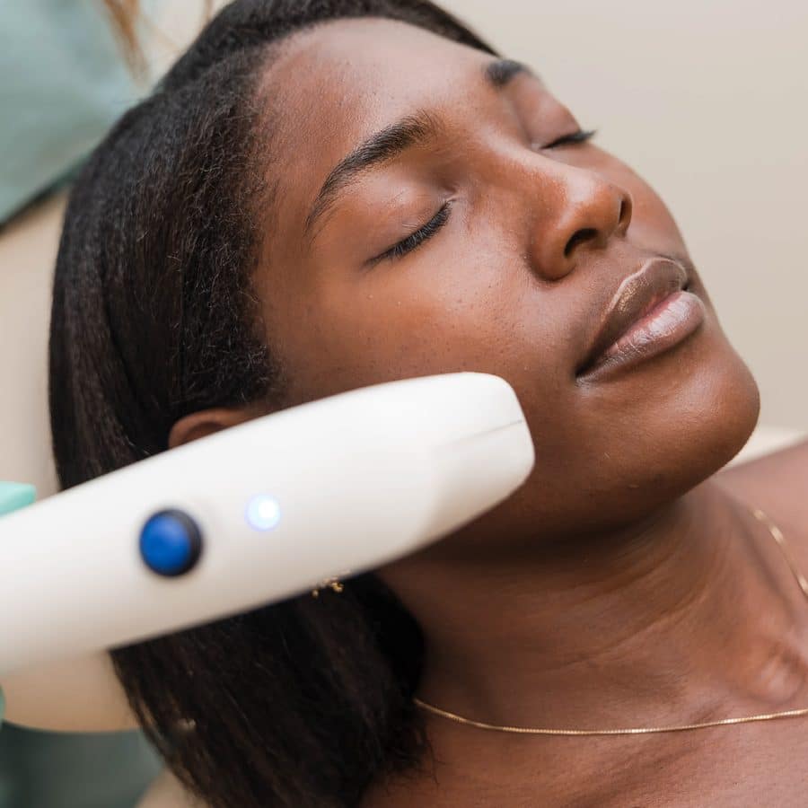 Woman relaxing during a Sofwave skin tightening treatment for the free add-on Sofwave package October special in Lakewood Ranch, Florida